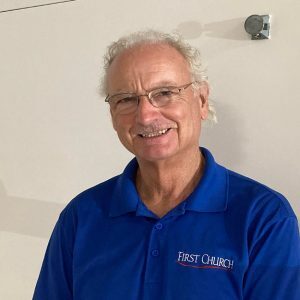 Staff member at First United Methodist Church of Sarasota wearing a blue First Church polo shirt