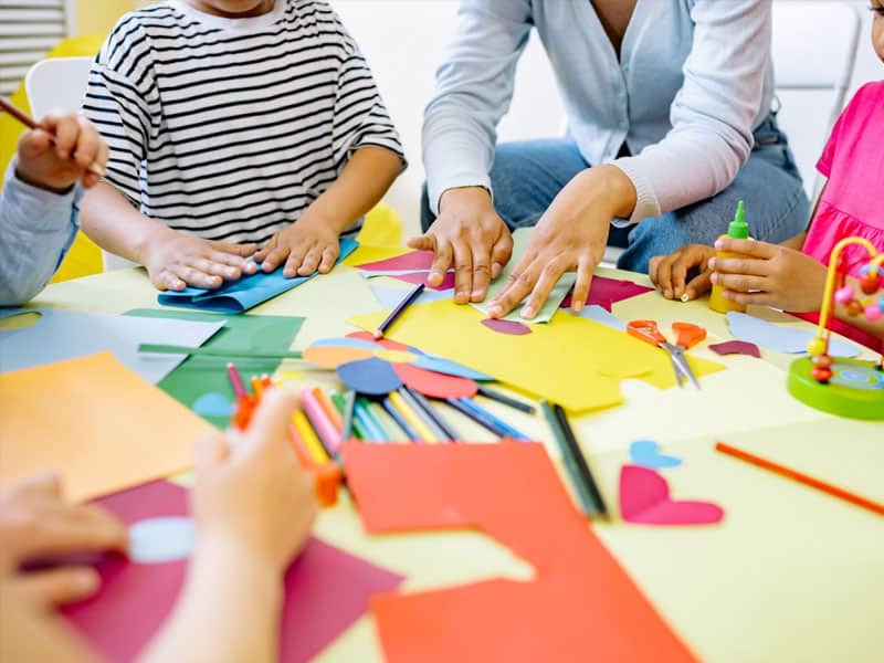 Children engaging in arts and crafts at an early care center.