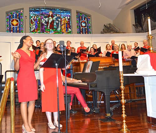Choir and soloists perform at First United Methodist Church of Sarasota during a music event.